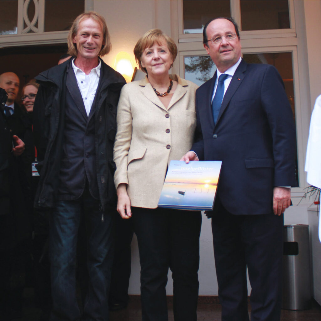 Robert Denier mit Angela Merkel und François Hollande